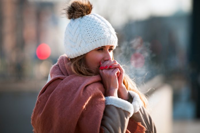 Woman,Breathing,On,Her,Hands,To,Keep,Them,Warm,At Staying Healthy in Winter